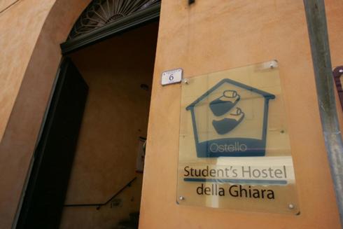 a sign on the side of a building at Student's Hostel Della Ghiara in Reggio Emilia