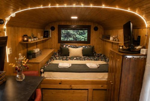 a bedroom with a bed in a tiny house at Maringotka MIMO in Uhelná