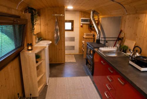 a small kitchen with a sink and a stove at Maringotka MIMO in Uhelná