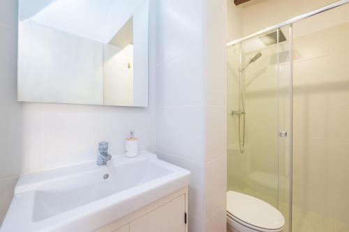 a bathroom with a sink and a toilet and a shower at Casa Margarita in Andratx