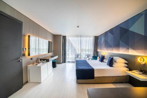 a hotel room with a large bed and a bathroom at Bosphorus Sorgun Hotel - Ultra All Inclusive in Side