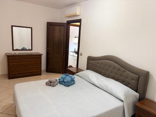 a bedroom with a bed with a teddy bear on it at L Isola in Càbras
