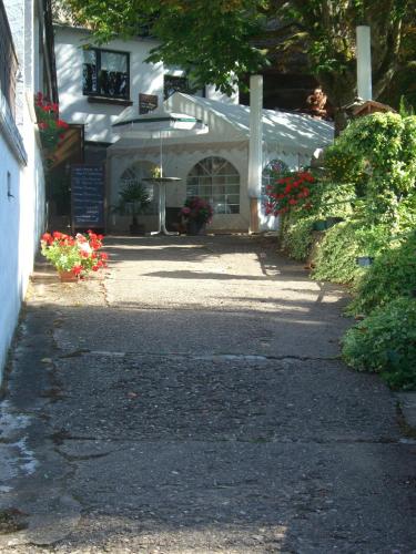 a white building with flowers in front of it at Hotel-Restaurant Burg-Ramstein in Kordel