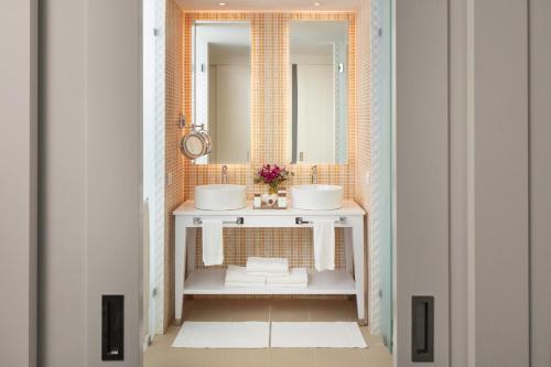 a bathroom with two sinks and a mirror at Azul Beach Resort Negril, Gourmet All Inclusive by Karisma in Negril