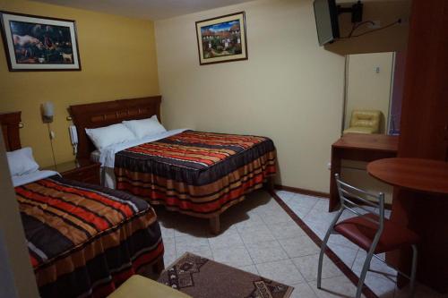 Posteľ alebo postele v izbe v ubytovaní Hostal El Imperio