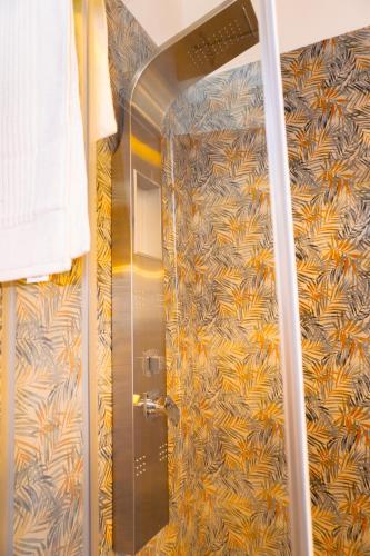 a shower in a bathroom with a colorful wall at Oliveta del Tabernacolo in Malmantile