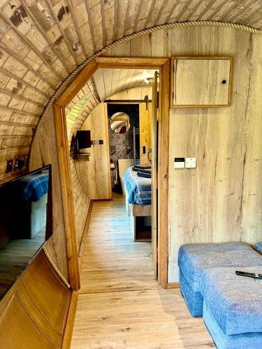 a small room with two beds in a train at Arts Hollow in Binegar