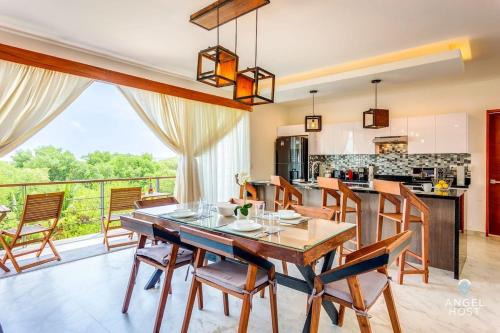 a kitchen and dining room with a table and chairs at Eight Condos Multi Listing in Playa del Carmen