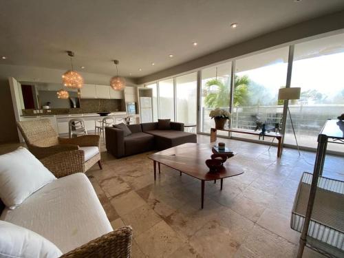 a living room with a couch and a table at Magia Multi Listings in Playa del Carmen