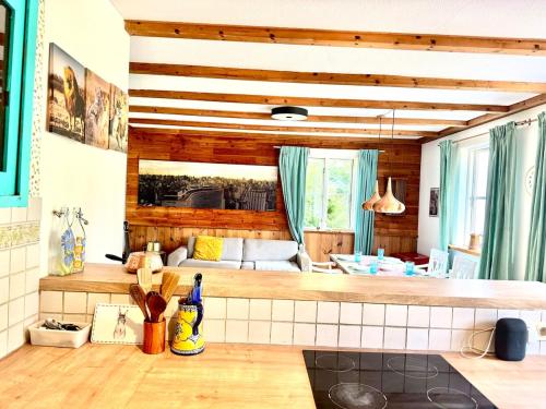 a kitchen with a counter and a living room at House at Jenischpark in Hamburg