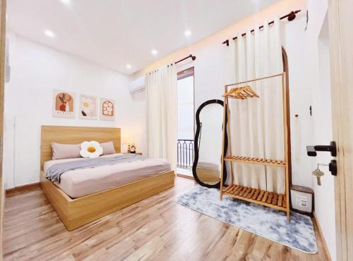 a bedroom with a bed and a mirror at Hyn's House in Danang