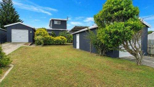 a house with a yard in front of it at On The Beach in Wooli