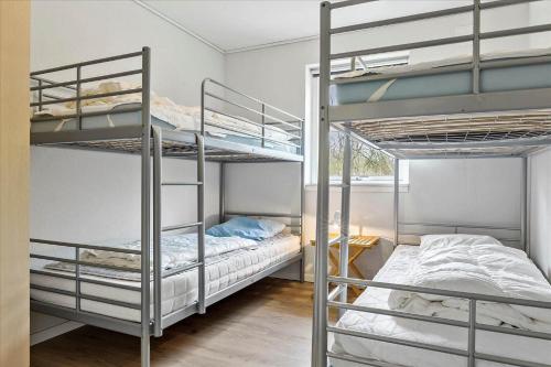 a bedroom with two bunk beds and a room with two beds at 0045-Romo-Thadesvej-13 in Høm