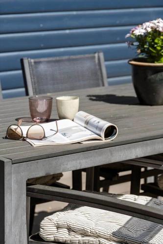 a wooden picnic table with a cup and a candle at 0664-Toftlund-Sydmarken-83 in Toftlund