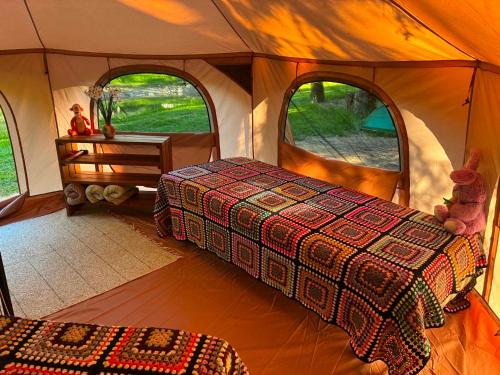 a room with a tent with two beds and two windows at Glamping Tent Tammemäe in Haapsi