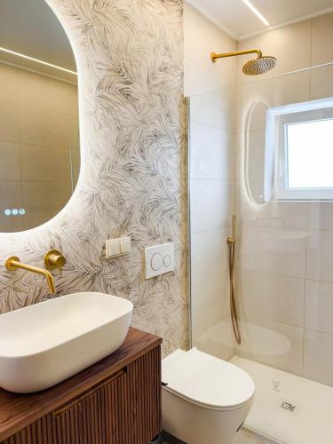 a bathroom with a sink and a toilet and a shower at Fernando Pessoa Villa in Faro