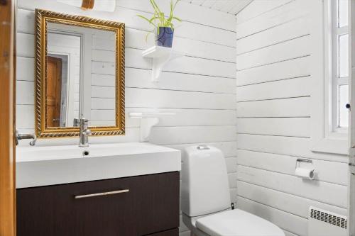a bathroom with a sink and a toilet and a mirror at 0663-Toftlund-Midtparken-84 in Toftlund