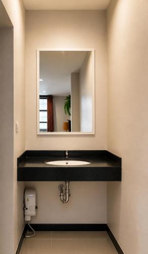 a bathroom with a sink and a mirror at SaintLove Hotel in Chiang Mai