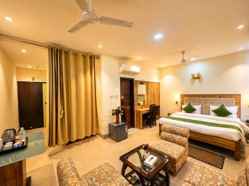 a hotel room with a bed and a living room at HOTEL LUXURY KASHI VISHWANATH- VARANASi in Varanasi