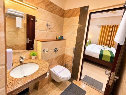 a bathroom with a sink and a toilet and a shower at HOTEL LUXURY KASHI VISHWANATH- VARANASi in Varanasi