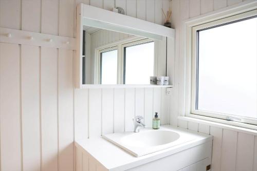 a white bathroom with a sink and a mirror at 13373-Asnaes-Radyrvej-24 in Asnæs