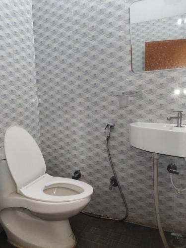 a bathroom with a toilet and a sink at Friendly Guest House in Gorakhpur