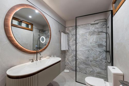a bathroom with a shower and a sink and a mirror at Marylanza Suites & Spa in Playa de las Americas