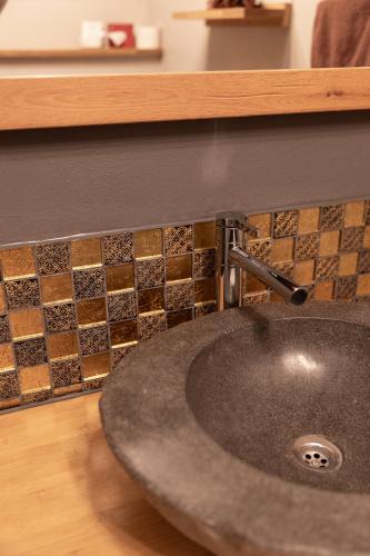 a bathroom sink with a faucet on a counter at Hotel Zur Post in Roßbach