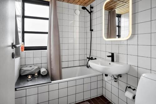 a bathroom with a sink and a bath tub at 530-Lemvig-Lokkevej-59-D in Lemvig