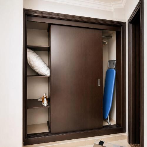 a closet with a brown door and a blue object at moon havena مون هافينا in Dhahran