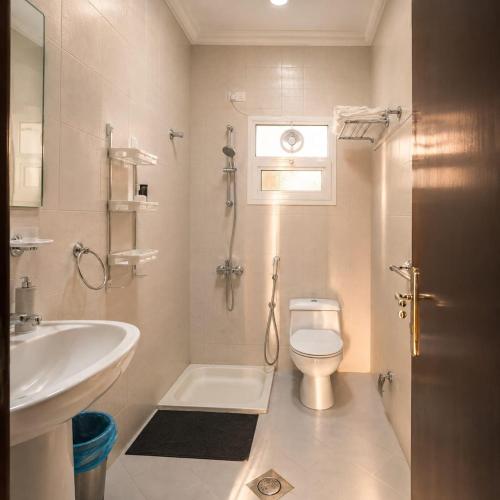 a bathroom with a toilet and a sink at moon havena مون هافينا in Dhahran