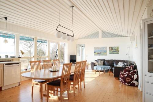 a kitchen and living room with a table and chairs at 14234-Grevinge-Strandmosen-11 in Grevinge