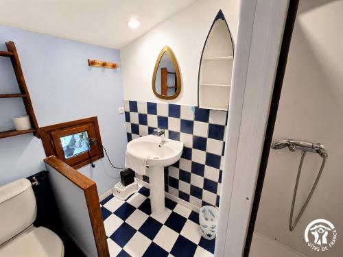 a small bathroom with a sink and a mirror at Moulin de Record in Ferrières