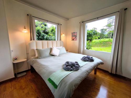 a bedroom with a bed with two towels on it at De Napa - Private Homestay in Ban Mae Na