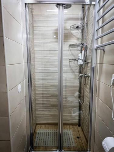 a shower with a glass door in a bathroom at Cantinho do Chico in Vila Nova de Gaia