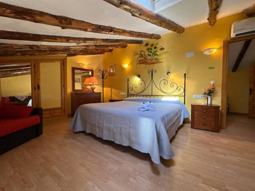 a bedroom with a large white bed in a room at Entrefrutales · Casa Rural entre Árboles y Aromas in La Vilueña
