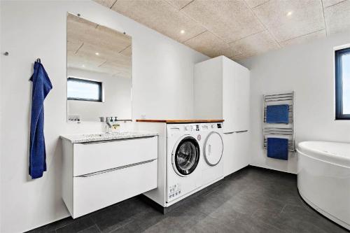 a white laundry room with a washer and dryer at 0431-Romo-Vestergade-333 in Høm