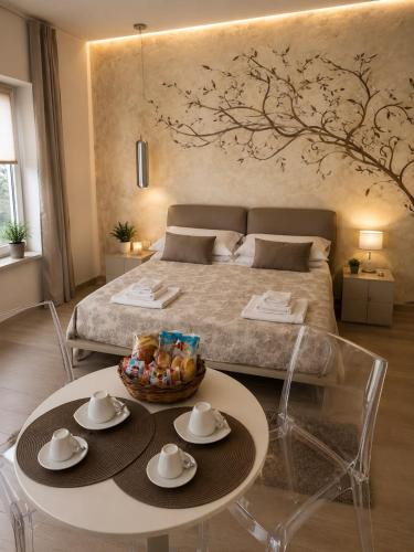 a bedroom with a bed and a table with two chairs at OLYMPUS PARK amnesia in Mesagne