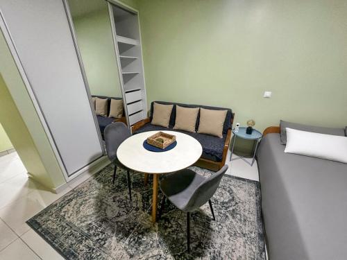 a living room with a couch and a table at AP2B Praia in Praia