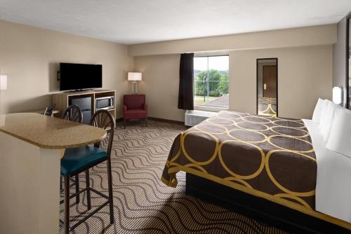 a hotel room with a bed and a desk at Super 8 by Wyndham Mars/Cranberry/Pittsburgh Area in Cranberry Township