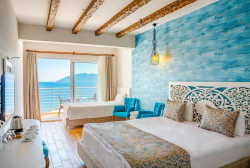 a bedroom with a bed and a view of the ocean at Casa Mare Bodrum in Bodrum City