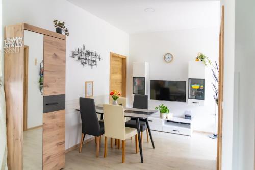 a dining room with a black table and chairs at Prenočišča Dany in Dravograd