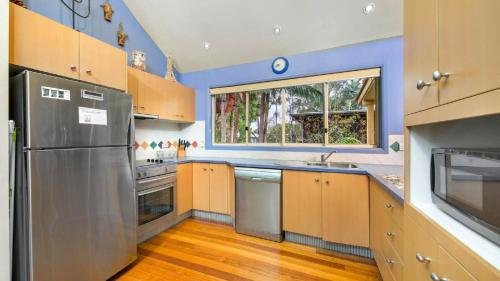 a kitchen with a stainless steel refrigerator and a window at MiaCasa in New Brighton