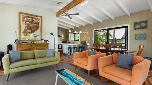 a living room with two chairs and a table at L'Aqua by Lifestyle. in New Brighton