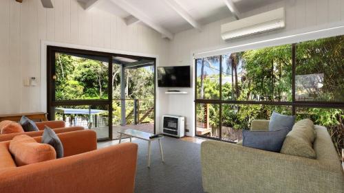 a living room with two couches and a large window at L'Aqua by Lifestyle. in New Brighton