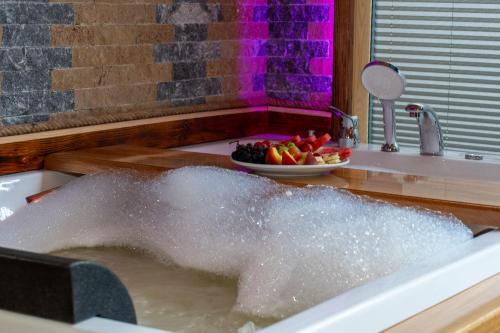 a bath tub filled with water in a sink at Gale Suit in Çamlıhemşin