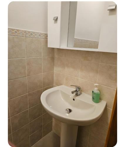 a bathroom with a white sink and a mirror at Appartamento Sestriere in Sestriere