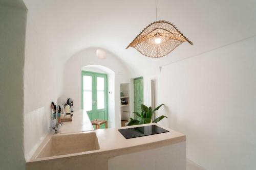 a kitchen with a sink and a mirror at vabè apulian accommodation in Ostuni
