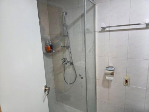 a bathroom with a shower with a glass door at Incheon Airport Yeongjong Guesthouse in Incheon