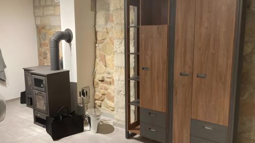 a wood stove in a bathroom with a stone wall at Ferienwohnung Für 4 Personen 90 M² in Naumburg